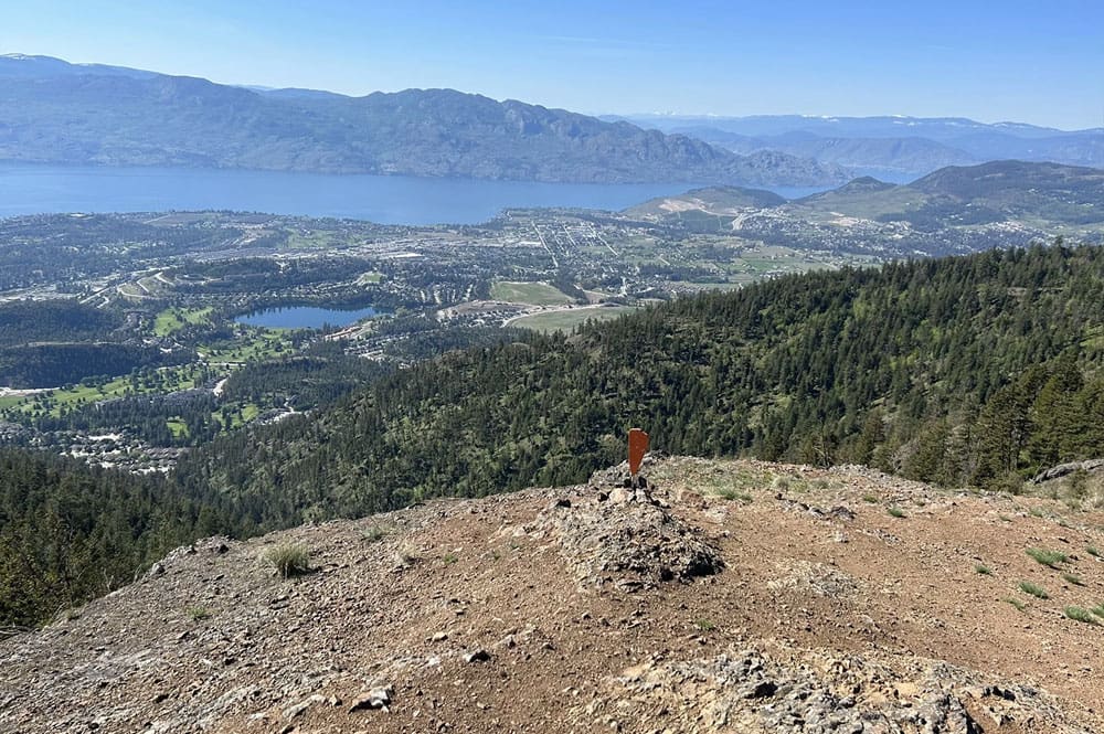 A high-up view from Carrot Mountain reveals an expansive scene of Shannon Lake, the golf course, and the community below, nestled in green hills.